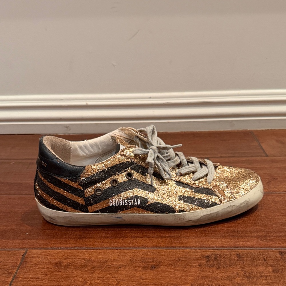 Golden Goose women’s Gold Glitter Sneakers with Black Stripes